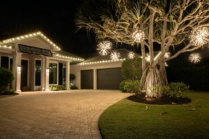 christmas light installation near you in naples fl 46 Night view of a luxury home decorated with warm white Christmas lights outlining the roof and spherical lights hanging from a tree in the front yard. The home features a brick driveway and dark garage doors.